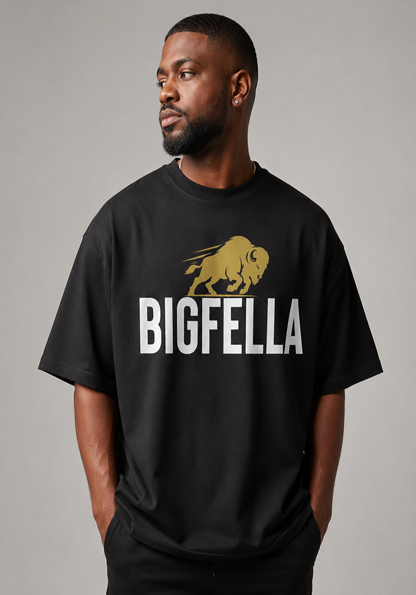 Man wearing a black t-shirt with 'BIGFELLA' and a bison graphic on a gray background